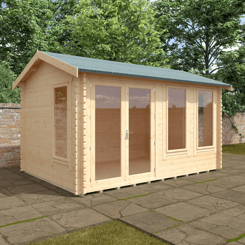 Wooden shed with a green roof on a stone patio with trees in the background