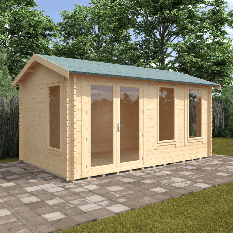 Wooden cabin with a green roof on a paved patio surrounded by trees