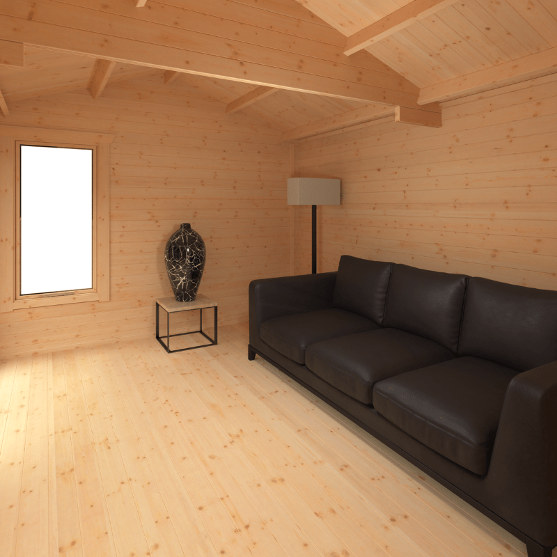 Living room with wooden walls and floor, black sofa, and a lamp.