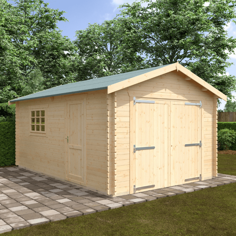 Wooden shed with a green roof on a paved area with trees in the background