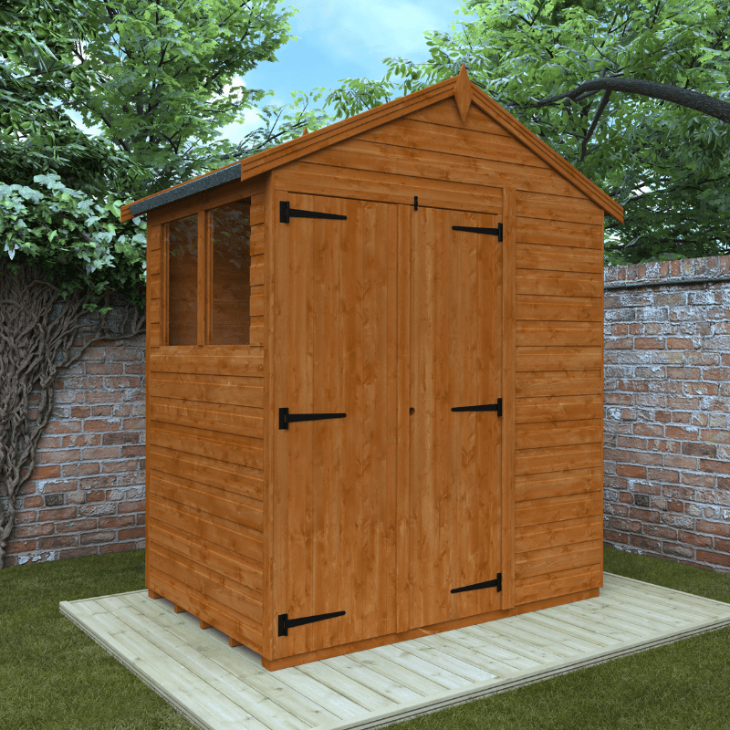 Wooden shed with a gabled roof in a garden setting with trees and a brick wall.