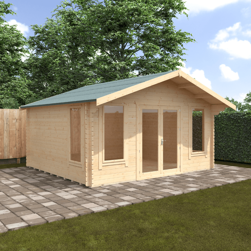 Wooden cabin with a green roof on a paved area with grass and trees in the background