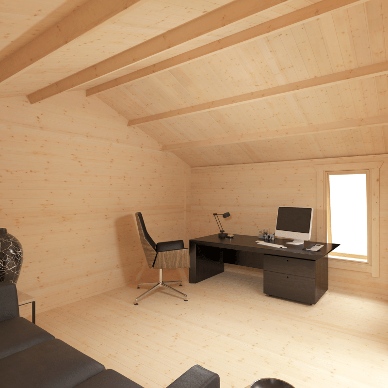 Wooden cabin interior with a desk, chair, and computer setup.