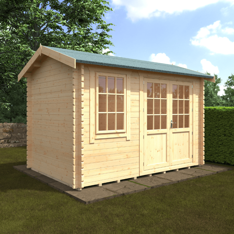 Wooden shed with a green roof on a grassy area with trees and blue sky in the background