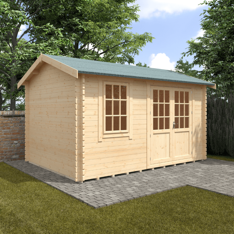 Wooden shed with a green roof on a grassy area with trees in the background