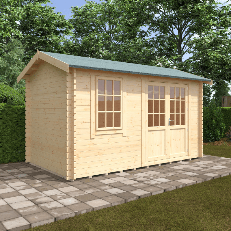 Wooden shed with a green roof on a paved area with trees in the background