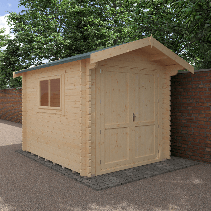 Wooden shed with a door and window on a paved area with trees in the background