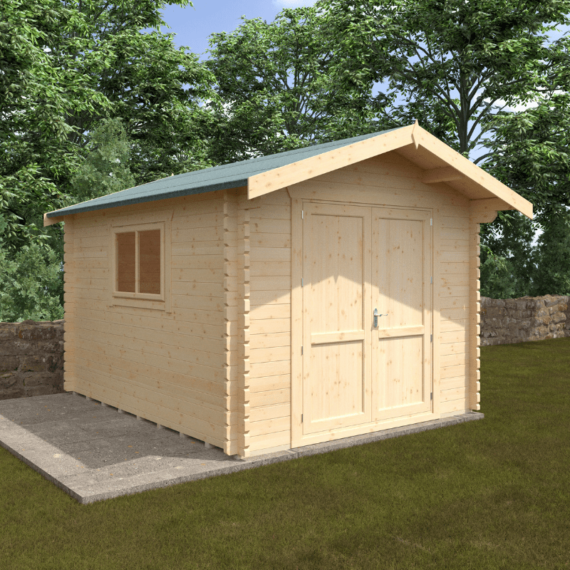 Wooden shed with a green roof on a grassy area with trees in the background