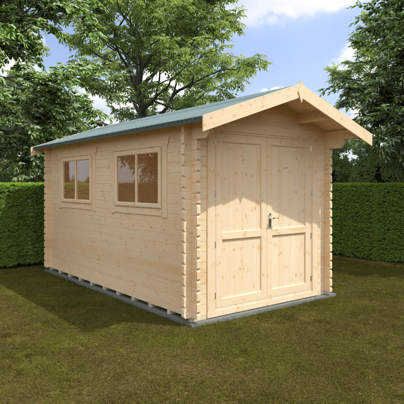 Wooden shed with a green roof on grass with trees in the background