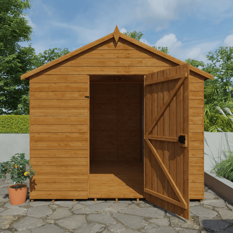Wooden shed with open door on a stone patio with greenery in the background