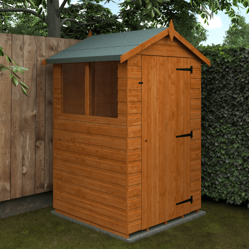 Wooden shed with a green roof in a garden setting