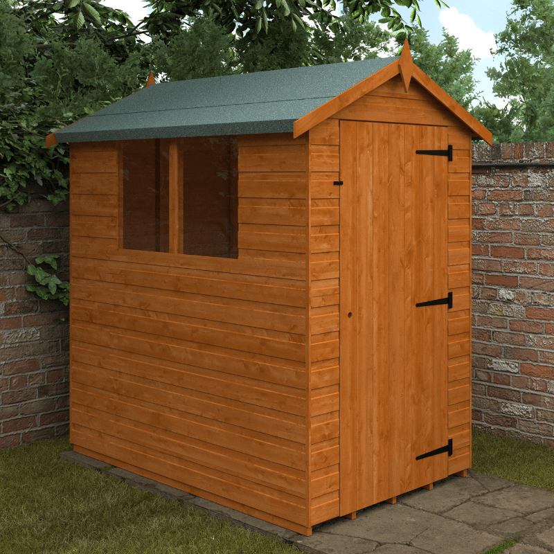 Wooden shed with a green roof against a brick wall and greenery