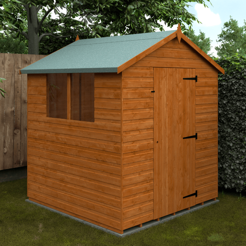Wooden shed with a green roof in a garden setting