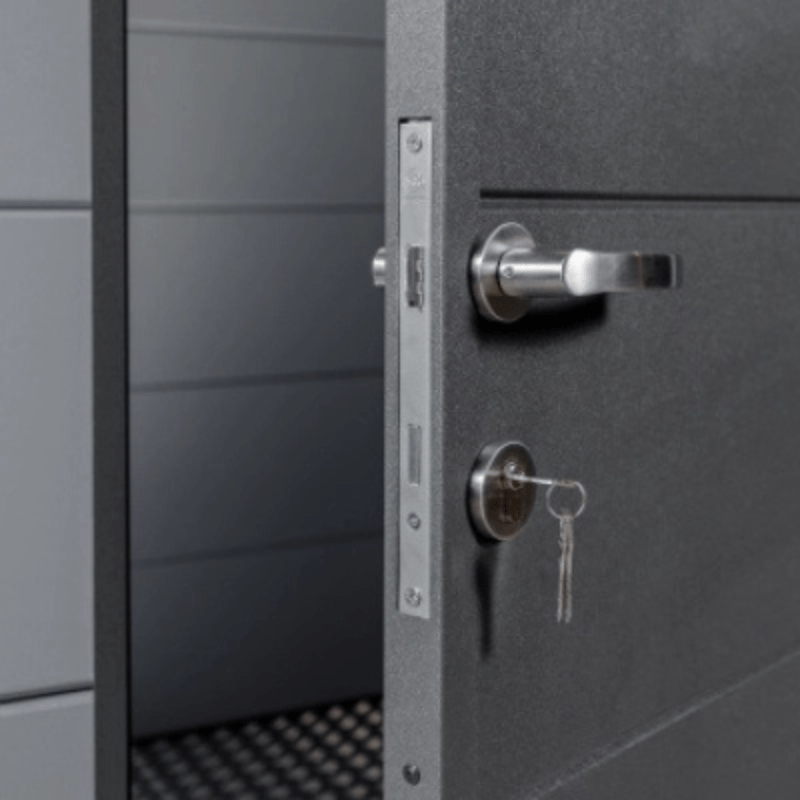 Close-up of a gray metal door with a lock and keyhole.