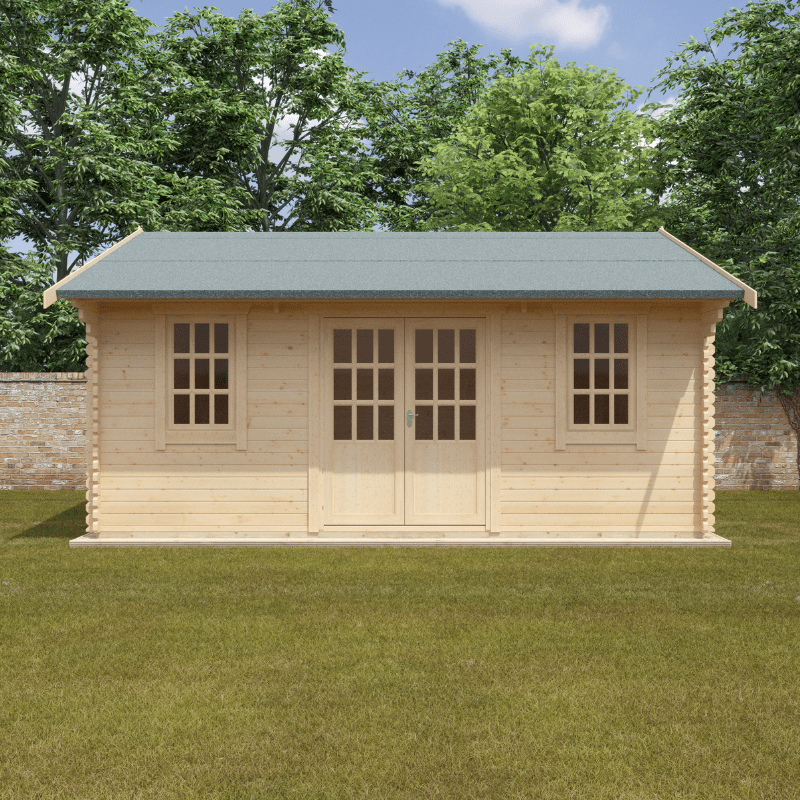 Wooden log cabin with a green roof on a grassy area with trees in the background