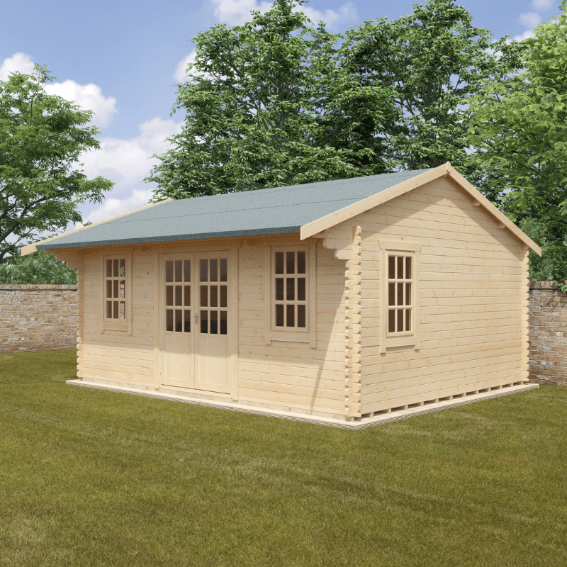 Wooden cabin with a green roof on a grassy area with trees in the background