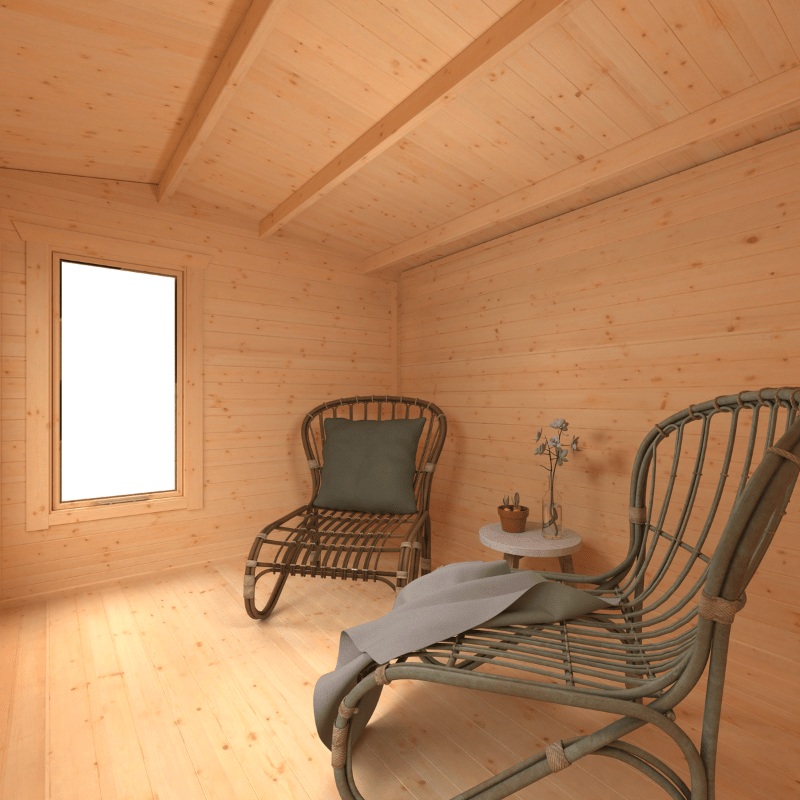 Wooden cabin interior with two chairs and a small table.