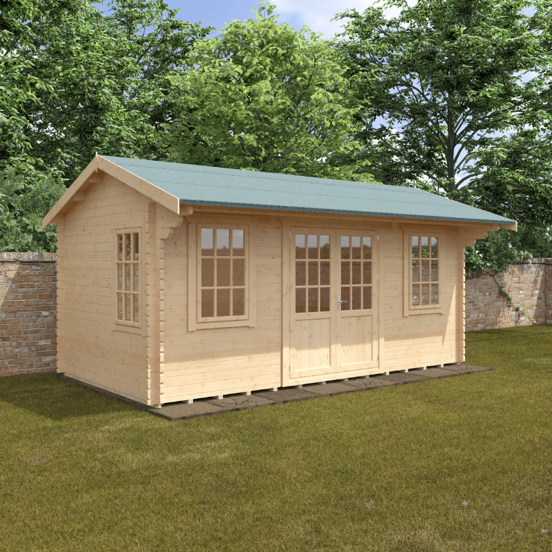 Wooden cabin with a green roof on a grassy area with trees in the background