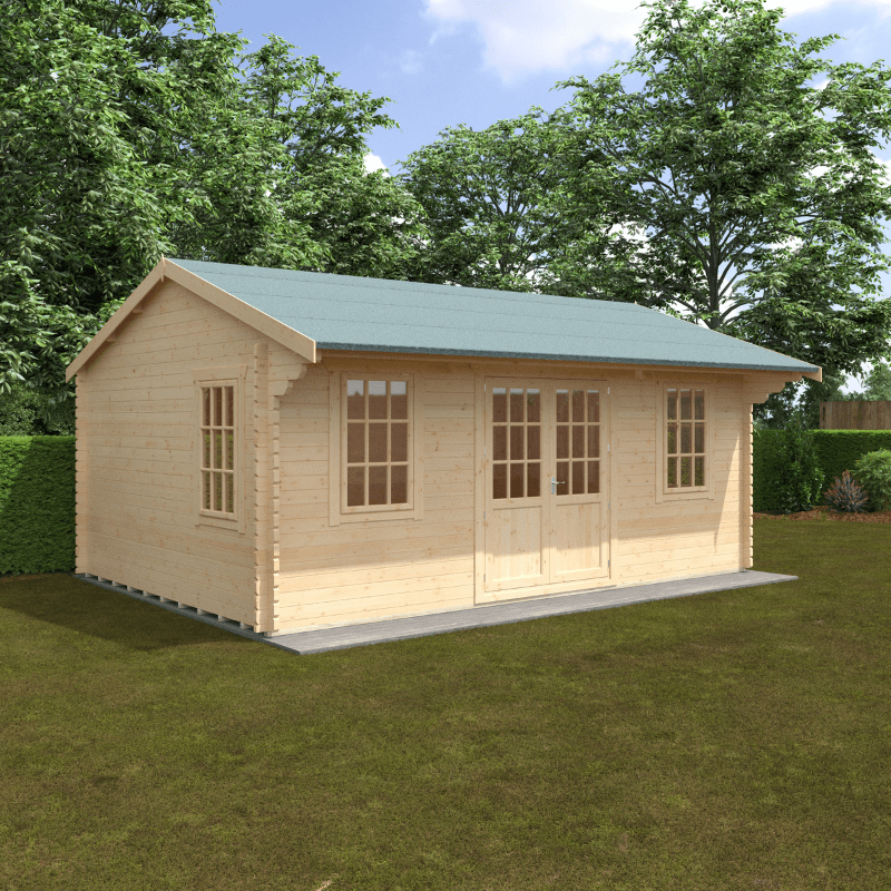 Wooden cabin with a green roof on a grassy area with trees in the background