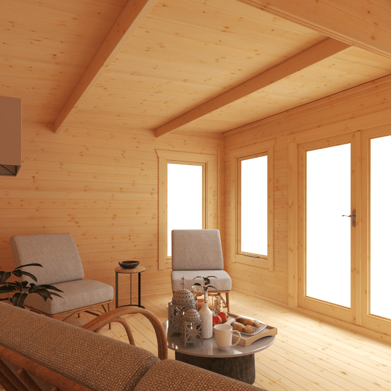 Wooden cabin interior with chairs, a table, and decor.