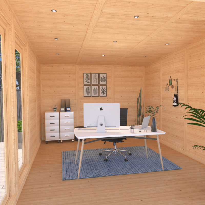 Wooden office cabin with a desk, computer setup, and decor.