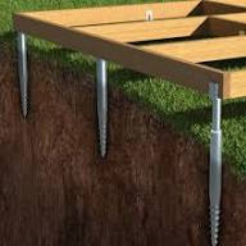 Wooden pallet with metal stakes on a grassy background