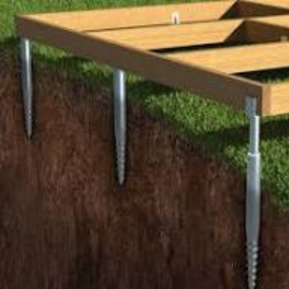 Wooden pallet with metal stakes on a grassy background