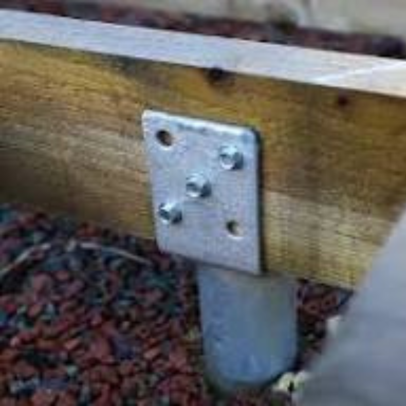 Metal bracket on a wooden surface with a blurred background