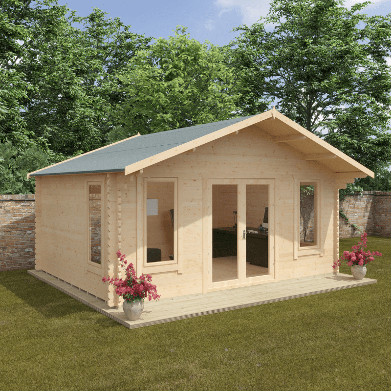 Wooden cabin with a green roof on a grassy area with trees in the background