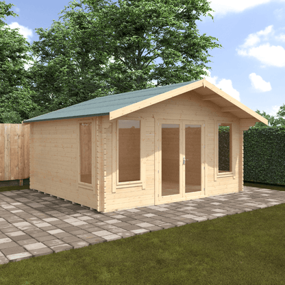Wooden cabin with a green roof on a paved area with grass and trees in the background