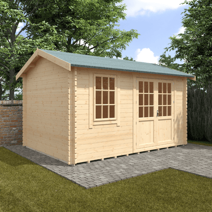 Wooden shed with a green roof on a grassy area with trees in the background
