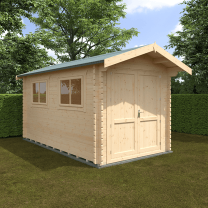 Wooden shed with a green roof on grass with trees in the background