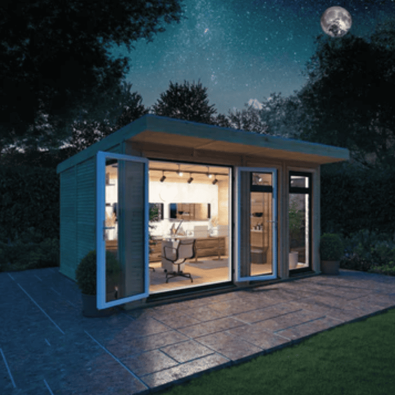 Modern garden office at night with open doors, illuminated interior, and starry sky.