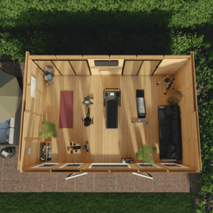 Top-down view of a wooden shed with furniture and items inside, surrounded by greenery.
