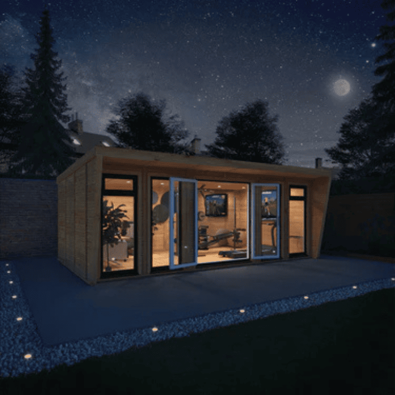 Modern cabin with large glass windows at night under a starry sky.