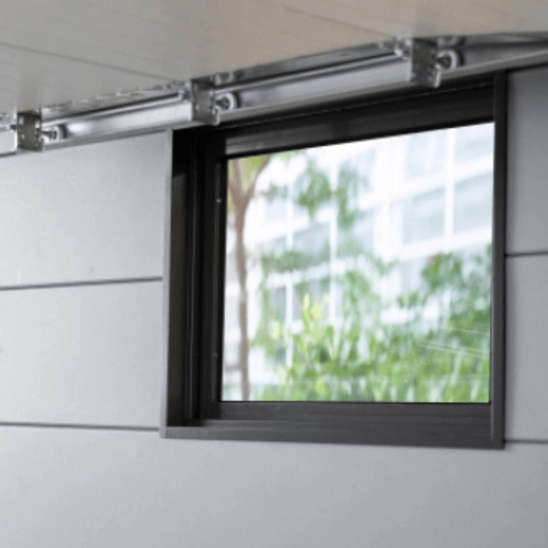 Section of a modern building with a glass window and metallic frame.