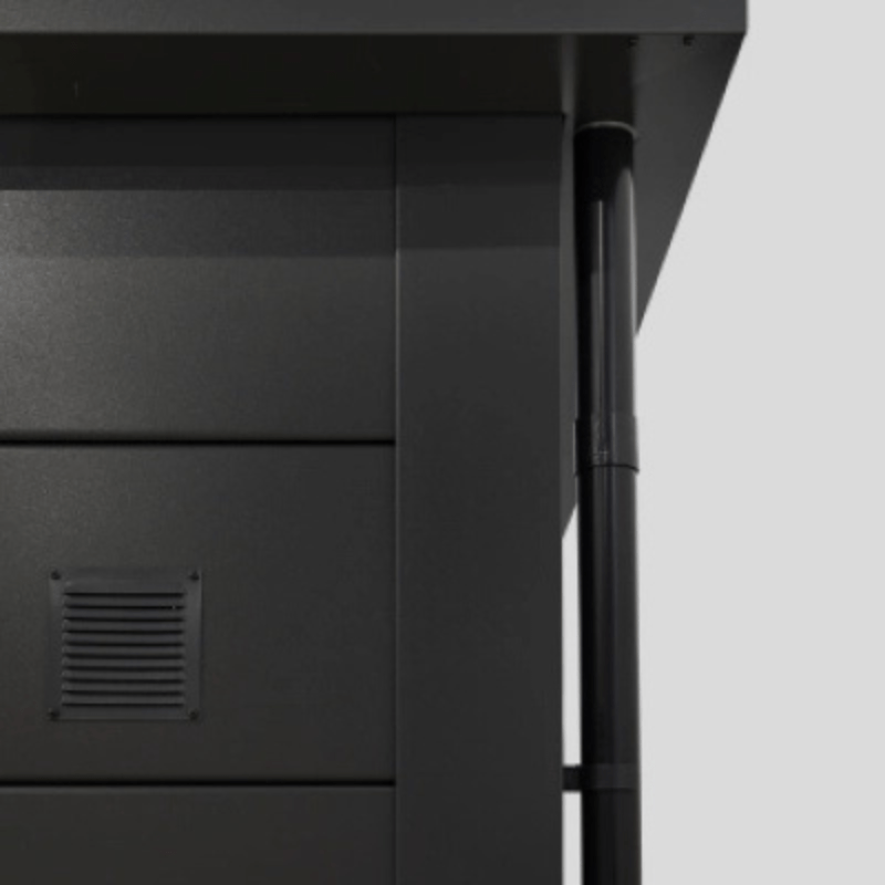 Close-up of a black metal cabinet with a vent on a gray background