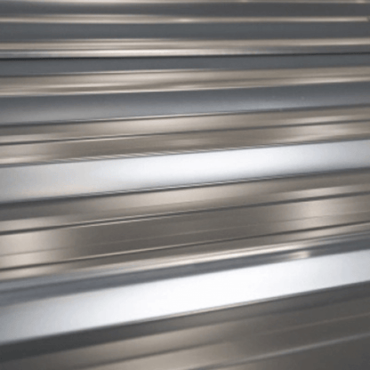 Close-up of metallic sheet with horizontal ribbed pattern