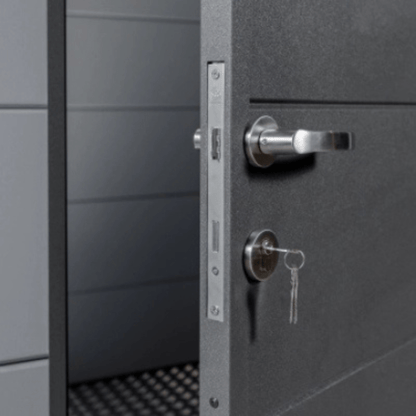 Close-up of a gray metal door with a lock and keyhole.