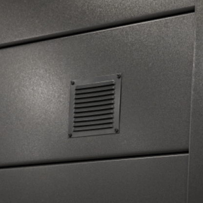 Metallic surface with a vent on a gray background
