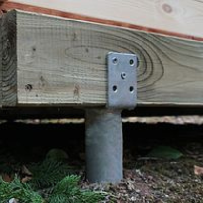 Wooden post with metal bracket on a wooden surface outdoors