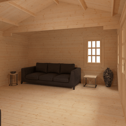 Wooden room with a dark gray sofa and small tables.