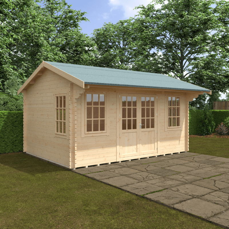 Wooden cabin with a green roof on a grassy area with trees in the background