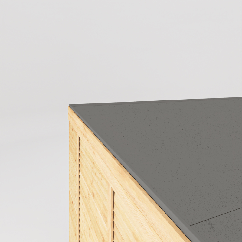 Corner of a wooden cabinet with a gray countertop on a light gray background