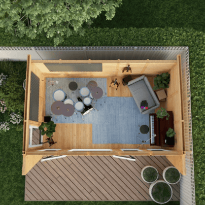 Top-down view of a small wooden cabin with furniture and decor on a grassy area.